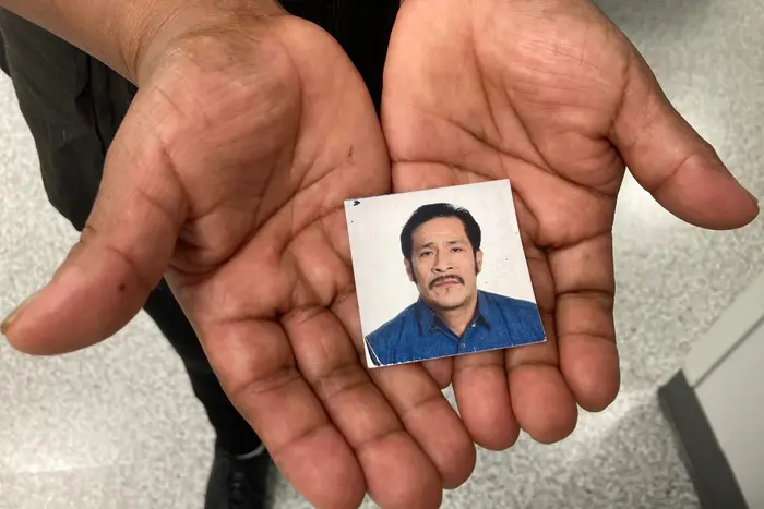 Luz Gualman holds a photograph of her late husband, Segundo Guallpa.
